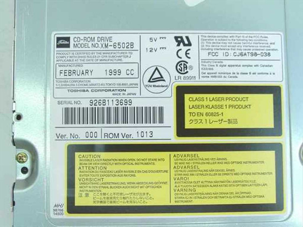 Toshiba XM-6502B CD-ROM Drive – close-up of rating plate showing model XM-6502B, February 1999 date, FCC ID CJ6AT9B-038, serial number, and ROM Ver. 1013