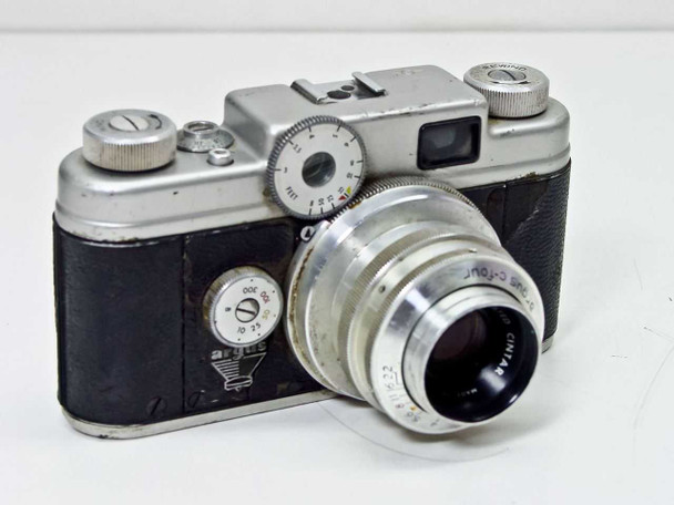 Argus C-Four 35mm rangefinder camera front-left three-quarter view with Coated Cintar 50mm f/2.8 lens and exposure meter dial visible