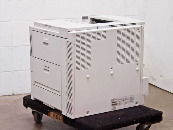 HP LaserJet 5Si MX C3167A — rear view showing ventilation panel and rating label, unit on roller dolly