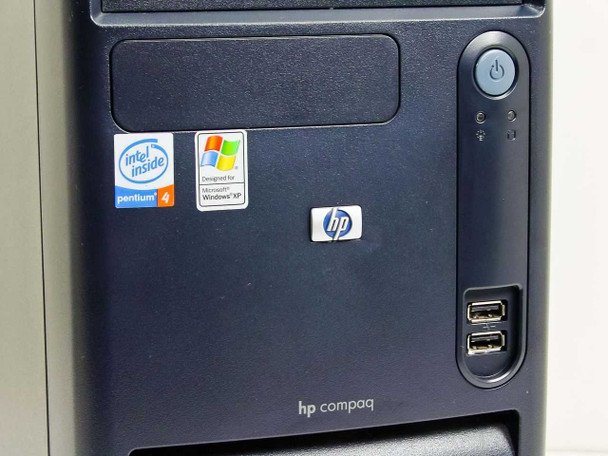 HP Compaq dx2000M front panel detail showing Intel Pentium 4 and Windows XP stickers, HP logo, and two front-panel USB 2.0 ports