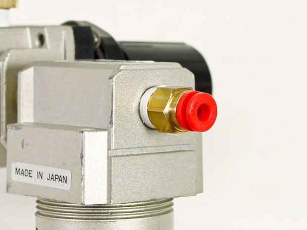 SMC NAF2000 air filter side close-up — Made in Japan label, red push-in port fitting visible on side outlet