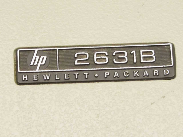 Close-up of HP 2631B Hewlett-Packard nameplate badge on printer front panel