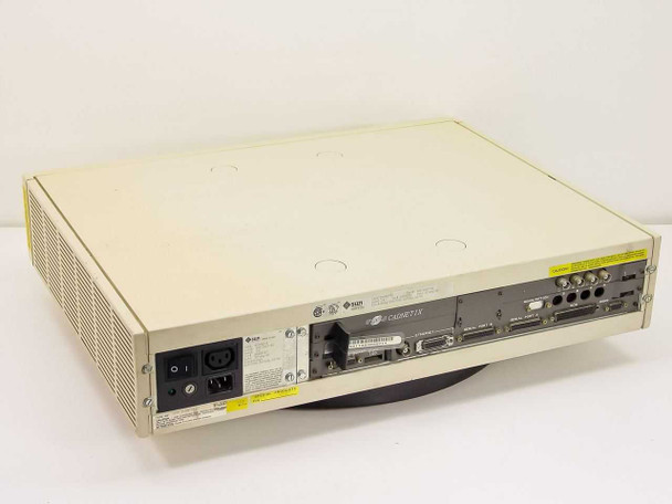 Sun 3/110 Prisum workstation rear view — shows power inlet, Sun Microsystems and Cadnetix branding labels, rear I/O ports and yellow caution sticker