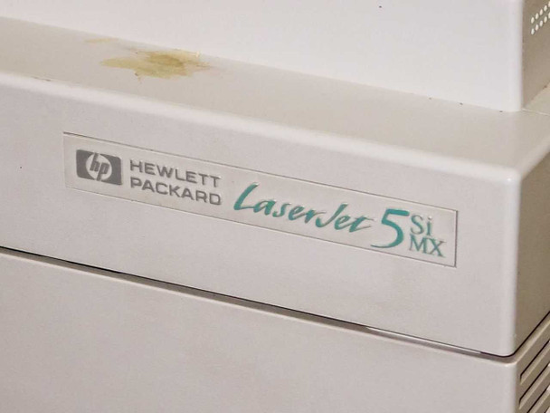 HP LaserJet 5Si MX logo badge closeup – yellowish stain visible on top housing above the badge
