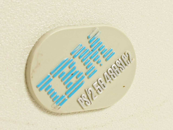 IBM PS/2 Model 56 badge close-up reading PS/2 56 486SLC2 on cream-colored bezel