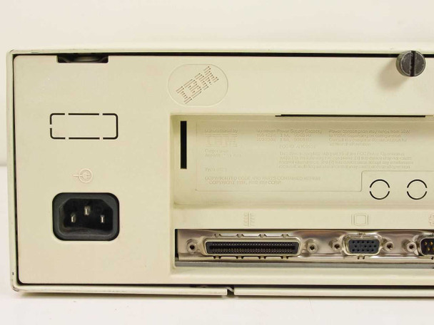 IBM PS/2 Model 56 rear panel closer view showing IEC power connector, IBM logo sticker, and rear I/O port strip with DB-25, DB-9, and mini-DIN connectors