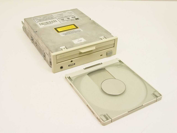 Toshiba XM-3401B 4x SCSI CD-ROM drive – top-angled view with caddy open beside the drive showing caddy tray and drive body with dust on top