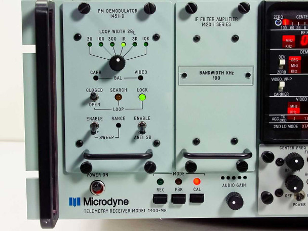 Microdyne 1400-MR front panel close-up showing PM Demodulator 1451-D, IF Filter Amplifier 1420 I Series, 100 KHz bandwidth selector, loop width controls, and REC/PBK/CAL mode switches
