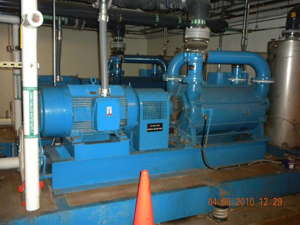 SIHI LPH 85353 vacuum pump skid — front quarter view showing Siemens motor, pump body with nameplate, and large-diameter inlet/outlet piping; orange traffic cone visible in foreground