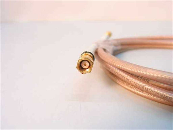Close-up of SMA male gold-plated connector end with cable jacket markings partially visible