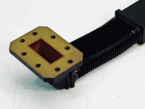 WR-137 waveguide 01007714-01 — close-up of brass flexible flange end showing rectangular aperture and corrugated flexible section