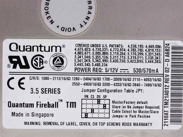 Quantum Fireball 2110AT label close-up — power specs 5/12V 530/570mA, C/H/S table, jumper config JP1, part number TM21A012 REV 02, Made in Singapore