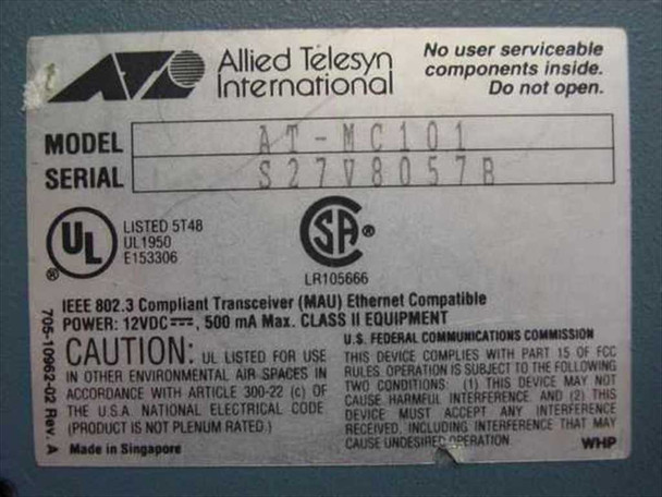 Allied Telesyn AT-MC101 bottom label showing model AT-MC101, serial number, UL/CSA certifications, IEEE 802.3 compliance, 12VDC 500mA rating, Made in Singapore