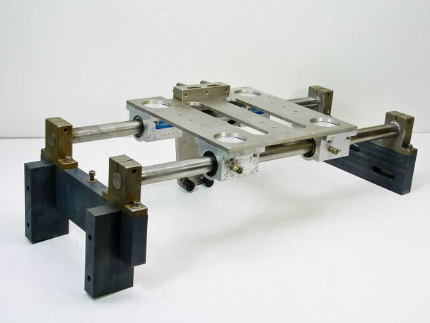 Thomson SSUPB16 linear guide assembly — opposite 3/4 angle showing dual parallel shafts, pillow blocks with blue Thomson labels, grease fittings, and aluminum table top