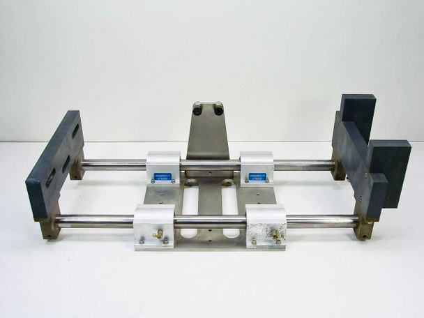Thomson SSUPB16 linear guide assembly — rear end view showing dual shafts, 4 SSUPB16 pillow blocks with blue labels, central carriage plate, and end support blocks