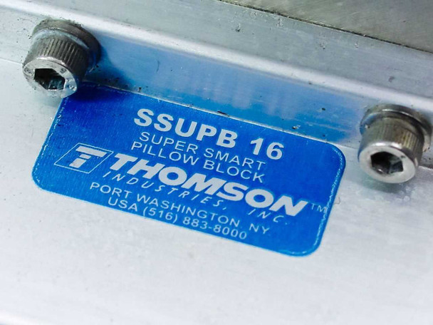 Close-up of blue Thomson Industries label on pillow block reading SSUPB16 Super Smart Pillow Block — Port Washington NY USA