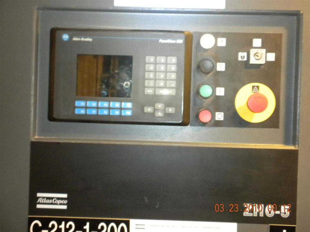 Atlas Copco ZH6-5 control panel close-up — Allen-Bradley PanelView 550 operator interface with keypad, green and red indicator lights, yellow emergency stop button, and Atlas Copco badge with partial model number C-212-1,200 / ZH6-5