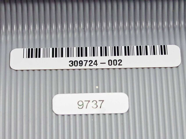 Exabyte 309724-002 part number label and date code label 9737 on flat ribbon cable surface