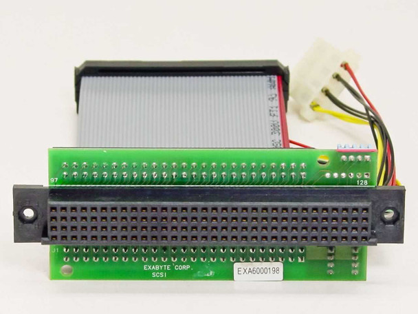Exabyte 309724-002 carrier cable PCB close-up showing 'EXABYTE CORP SCSI' silk screen, EXA6000198 label, and 128-pin edge connector pins numbered 97–128
