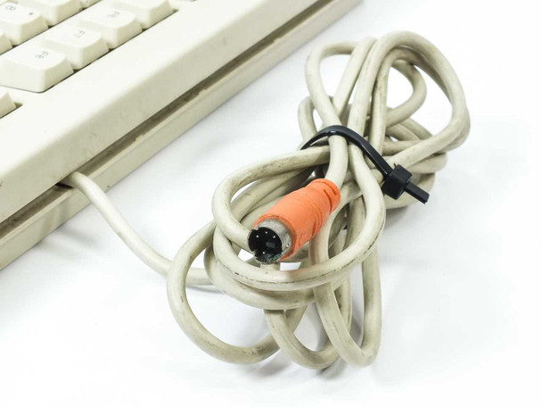 Compaq RT235BTW keyboard PS/2 cable close-up showing orange 6-pin Mini-DIN PS/2 connector