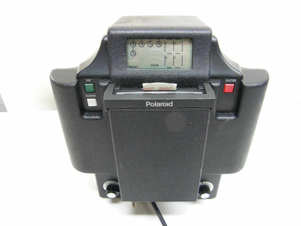 Polaroid MX-4 passport ID photo camera – operator front view showing LCD display, B/W and shutter buttons, film slot, and Polaroid logo