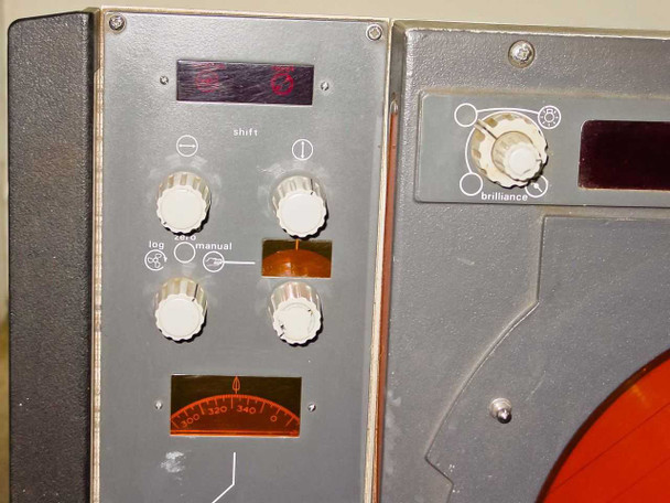 Close-up of Decca Radar TMS1230C display console left-side controls — log, sea, manual knobs, shift control, brilliance knob, and analog bearing indicator