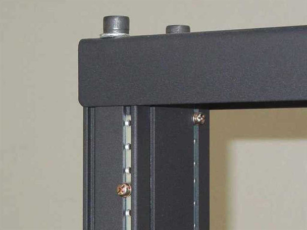 Close-up of upper rack rail corner showing threaded mounting holes, rack unit markings on rail, and mounting screws installed