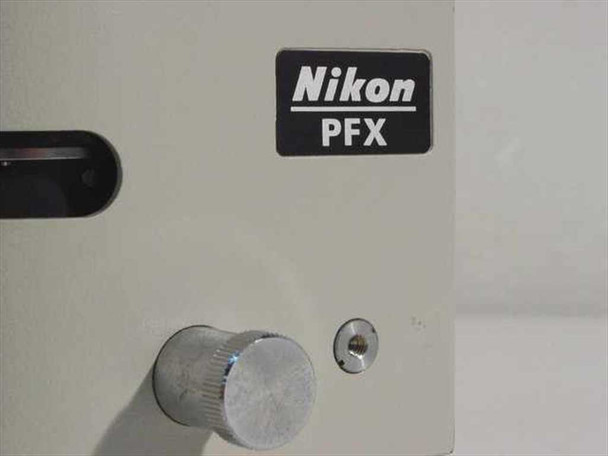 Nikon PFX shutter body close-up showing model name plate and large aluminum control knob with small port to the right