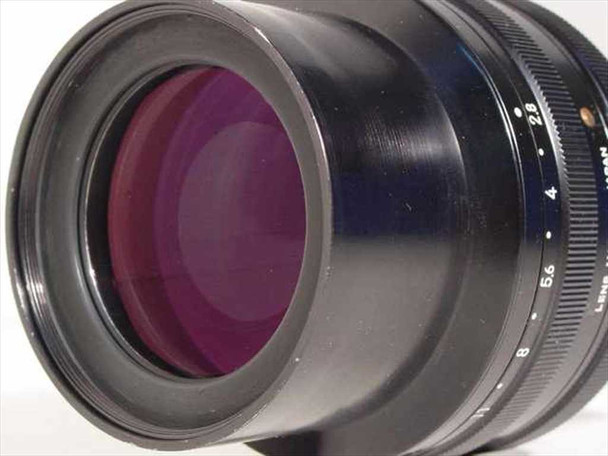 Three-quarter front view of Nikon Printing-Nikkor 105mm f/2.8 showing multi-coated magenta front element and aperture scale