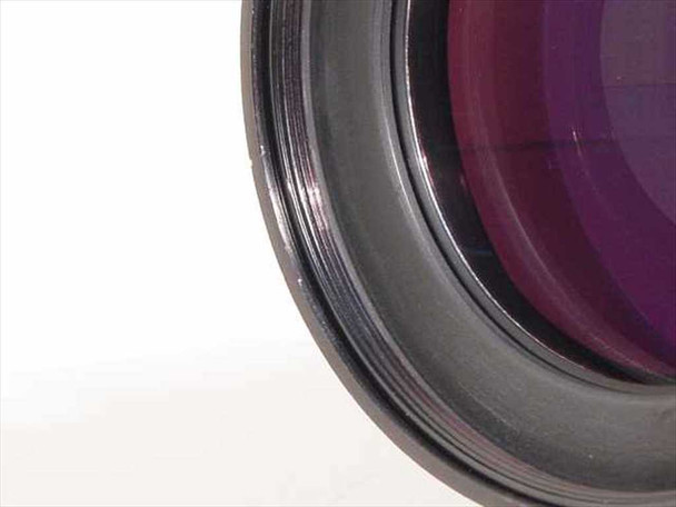 Close-up of upper-left quadrant of Nikon Printing-Nikkor 105mm f/2.8 front element showing lens coating and barrel edge