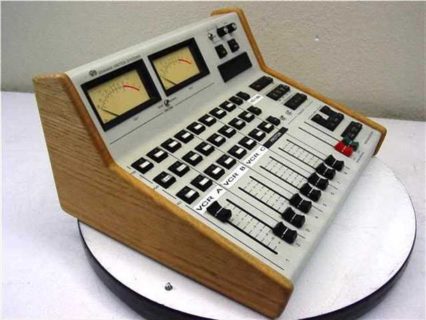 Graham Patton Systems 608 Audio Mixer – left-side 3/4 angle view showing angled console profile, wood side cheeks, faders, and button rows