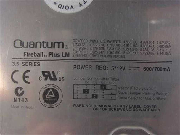 Quantum Fireball Plus LM bottom label showing brand name, 3.5 Series, power requirements 5V/12V 600/700mA, jumper configuration table, CE and UL markings, Made in Japan