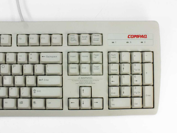 Compaq RT235BTW keyboard top-right section showing function keys F9-F12, navigation cluster, numeric keypad, and Compaq logo badge