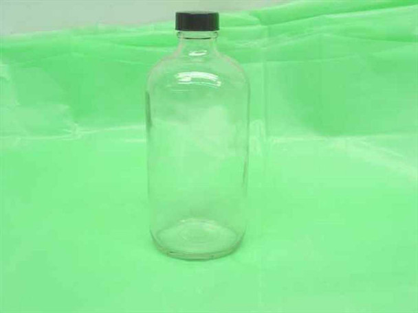 Qorpak 16 oz clear glass Boston Round bottle with black screw cap — close-up front view showing clean, unused condition