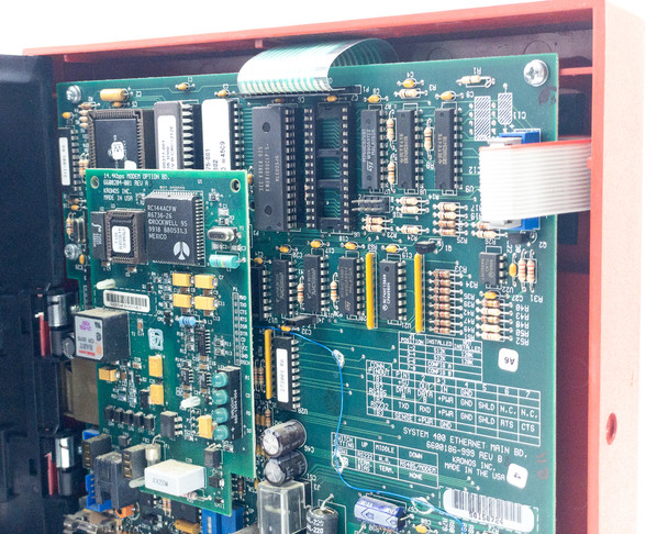 Kronos 460F interior close-up showing FK Modem PROM option board with ICs and ribbon cable connecting to Ethernet main board