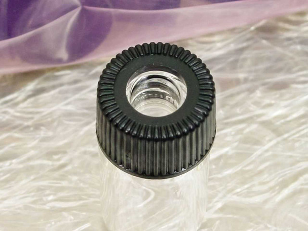 Top-down close-up of black open-top polypropylene screw cap on Comar 2 mL glass vial showing open center and knurled cap edge