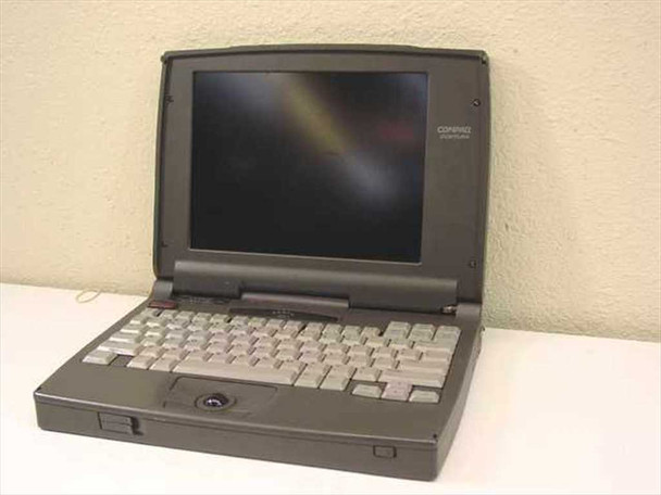 Compaq Contura 430C 2860C vintage laptop open, showing color LCD screen, keyboard, and integrated trackball — front three-quarter view