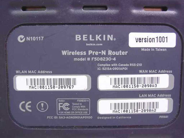 Belkin F5D8230-4 bottom label showing model F5D8230-4, version1001, Made in Taiwan, FCC ID SA3-AGN0901AP0100, WLAN/WAN/LAN MAC addresses, and regulatory markings