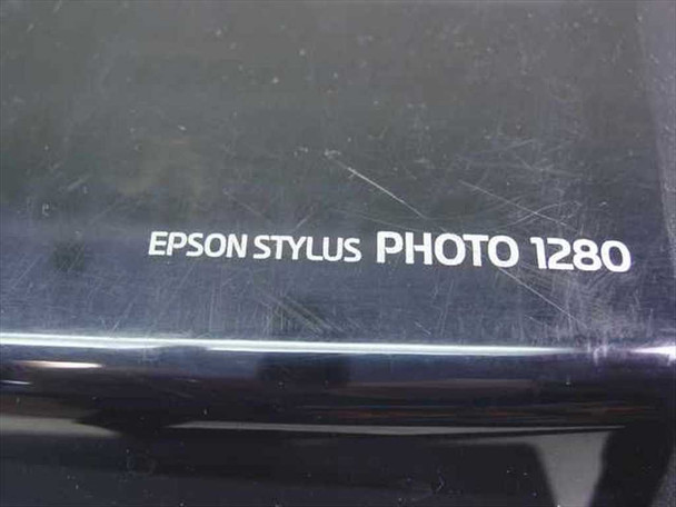 Close-up of Epson Stylus Photo 1280 model name label on top cover showing light surface scratches