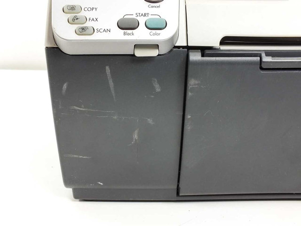 HP OfficeJet 5510 front lower panel close-up showing scratches and scuff marks on the dark gray plastic housing