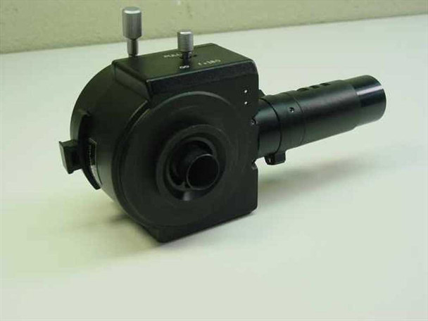 Olympus epi-illuminator – opposite side view showing front aperture port, two thumbscrews on top, and illuminator tube