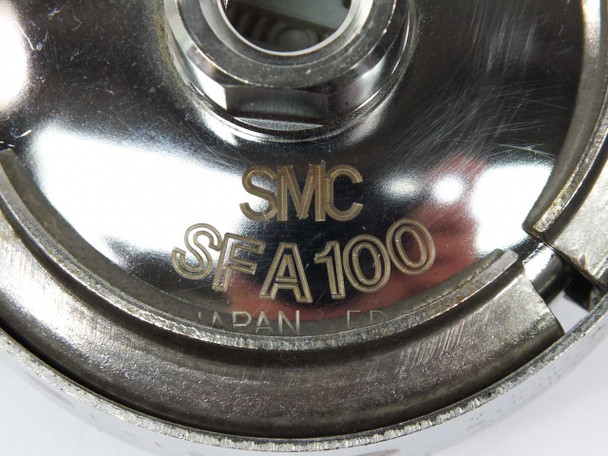 SMC SFA100 model label close-up showing 'SMC SFA100 JAPAN' engraved on stainless disc housing
