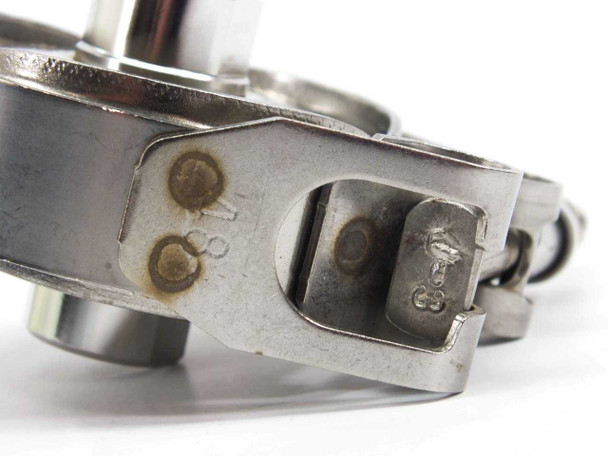 SMC SFA100 filter cartridge – underside edge view of clamp tabs showing stamped size markings and minor surface wear
