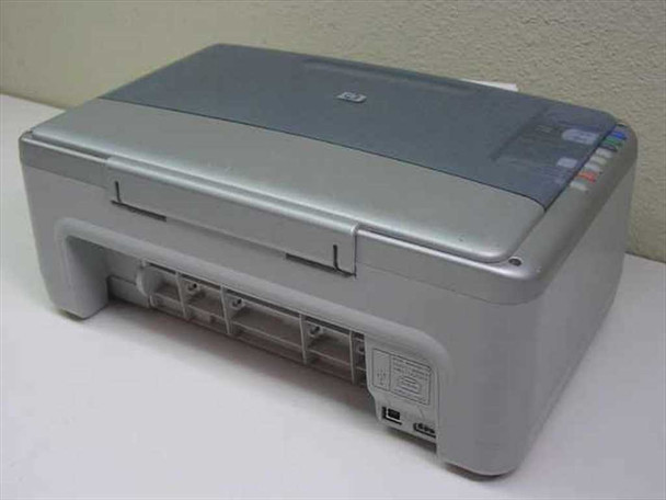 HP PSC 1315xi — rear three-quarter view showing paper trays, USB port, and power connector area