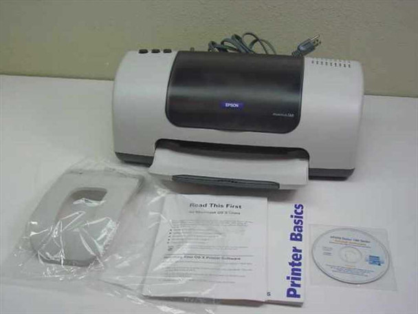 Epson Stylus C60 printer front view with included accessories: paper support, Read This First guide, Printer Basics booklet, and driver CD