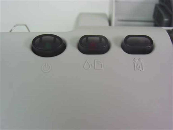 Close-up of Epson Stylus C60 front panel showing power button, ink/paper indicator button, and cleaning button