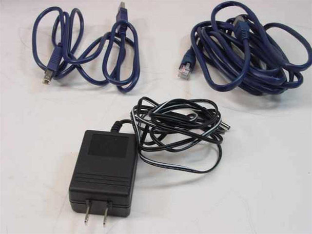 Included accessories for Netgear ME102: USB cable, RJ-45 Ethernet cable, and black AC power adapter