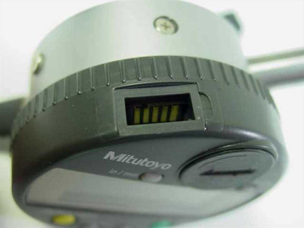 Mitutoyo ID-C112E side view showing data output port connector and in/mm selector switch on the body