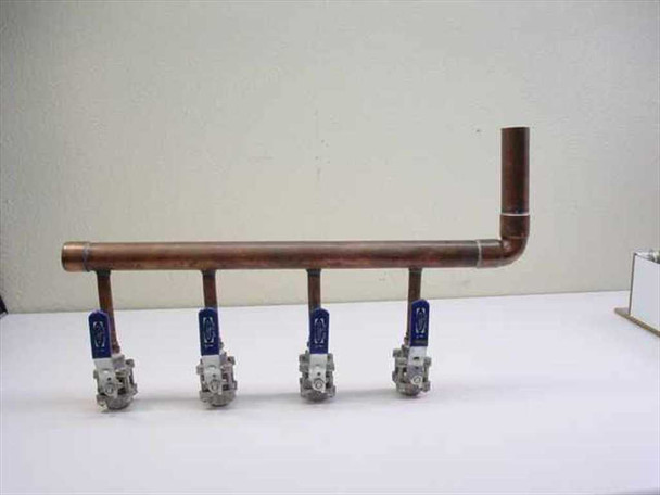 Nibco 4-zone chilled water manifold – side profile showing full copper pipe run, 90-degree elbow at right end, and four downward-facing brass ball valves