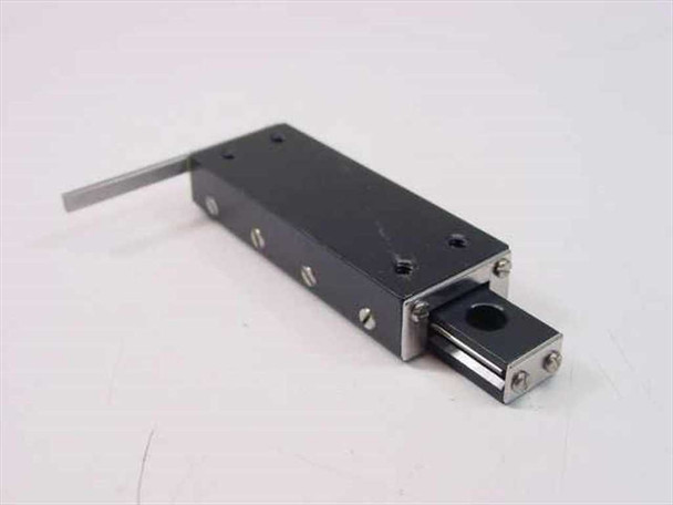 Del-Tron linear stage 20x54mm — angled side view showing carriage extended with 25mm stroke range and drive screw assembly with circular locking knob